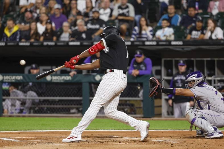 Sep 13, 2022; Chicago, Illinois, USA; Chicago White Sox left fielder Eloy Jimenez (74) hits a three-run home run against the Colorado Rockies during the first inning at Guaranteed Rate Field. Mandatory Credit: Kamil Krzaczynski-USA TODAY Sports