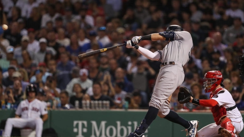 Sep 13, 2022; Boston, Massachusetts, USA; New York Yankees center fielder Aaron Judge (99) hits a home run during the sixth inning against the Boston Red Sox at Fenway Park. Mandatory Credit: Paul Rutherford-USA TODAY Sports