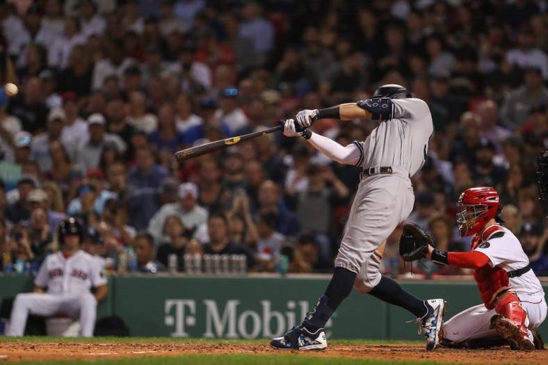 Sep 13, 2022; Boston, Massachusetts, USA; New York Yankees center fielder Aaron Judge (99) hits a home run during the sixth inning against the Boston Red Sox at Fenway Park. Mandatory Credit: Paul Rutherford-USA TODAY Sports
