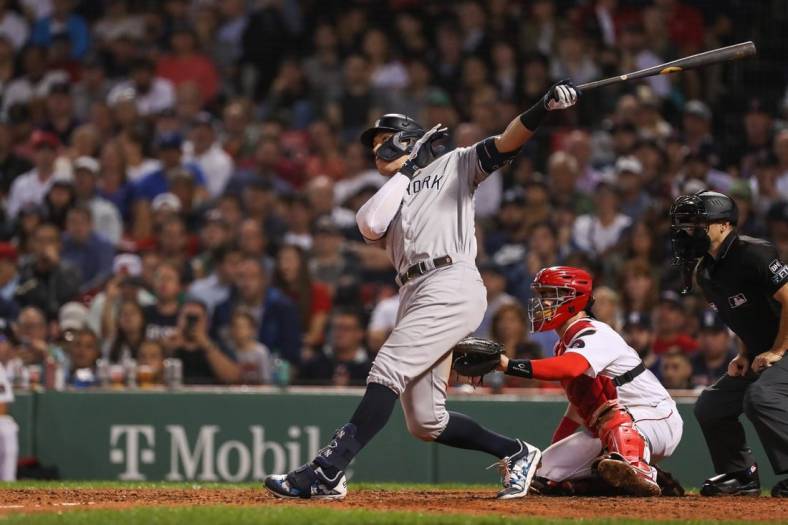 Sep 13, 2022; Boston, Massachusetts, USA; New York Yankees center fielder Aaron Judge (99) hits a home run during the eighth inning against the Boston Red Sox at Fenway Park. Mandatory Credit: Paul Rutherford-USA TODAY Sports