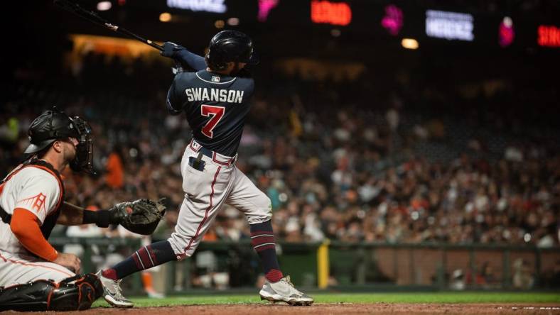 Sep 13, 2022; San Francisco, California, USA;  Atlanta Braves shortstop Dansby Swanson (7) hits a two run home run during the third inning against the San Francisco Giants at Oracle Park. Mandatory Credit: Ed Szczepanski-USA TODAY Sports