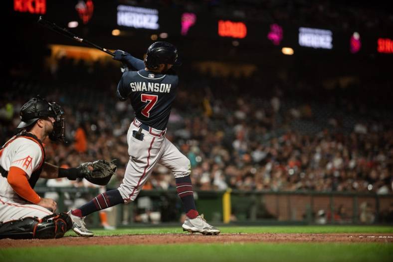 Sep 13, 2022; San Francisco, California, USA;  Atlanta Braves shortstop Dansby Swanson (7) hits a two run home run during the third inning against the San Francisco Giants at Oracle Park. Mandatory Credit: Ed Szczepanski-USA TODAY Sports