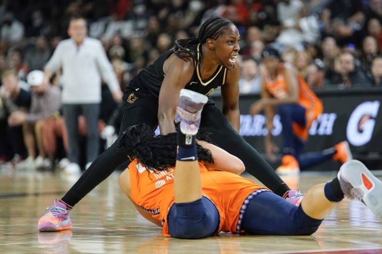 Sep 13, 2022; Las Vegas, Nevada, USA; Las Vegas Aces guard Chelsea Gray (12) reacts to being fouled by Connecticut Sun forward Brionna Jones (42) during the second quarter in game two of the WNBA Finals at Michelob Ultra Arena. Mandatory Credit: Lucas Peltier-USA TODAY Sports