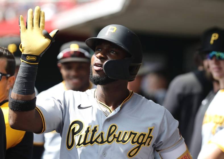 Sep 14, 2022; Cincinnati, Ohio, USA; Pittsburgh Pirates shortstop Rodolfo Castro (14) celebrates in the dugout after hitting a three-run home run against the Cincinnati Reds during the third inning at Great American Ball Park. Mandatory Credit: David Kohl-USA TODAY Sports