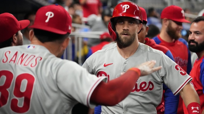 Sep 14, 2022; Miami, Florida, USA; Philadelphia Phillies designated hitter Bryce Harper (3) celebrates in the dugout after hitting a solo home run in the sixth inning against the Miami Marlins at loanDepot park. Mandatory Credit: Jasen Vinlove-USA TODAY Sports