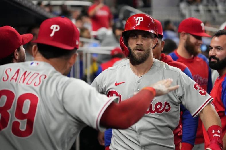 Sep 14, 2022; Miami, Florida, USA; Philadelphia Phillies designated hitter Bryce Harper (3) celebrates in the dugout after hitting a solo home run in the sixth inning against the Miami Marlins at loanDepot park. Mandatory Credit: Jasen Vinlove-USA TODAY Sports