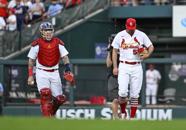 Sep 14, 2022; St. Louis, Missouri, USA;  St. Louis Cardinals catcher Yadier Molina (4) and starting pitcher Adam Wainwright (50) walk in from the bullpen before their 325th start as a battery breaking the MLB record before a game against the Milwaukee Brewers at Busch Stadium. Mandatory Credit: Jeff Curry-USA TODAY Sports