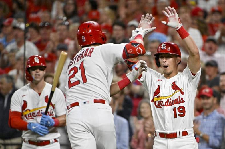 Sep 14, 2022; St. Louis, Missouri, USA;  St. Louis Cardinals center fielder Lars Nootbaar (21) is congratulated by second baseman Tommy Edman (19) after hitting a solo home run against the Milwaukee Brewers during the fifth inning at Busch Stadium. Mandatory Credit: Jeff Curry-USA TODAY Sports