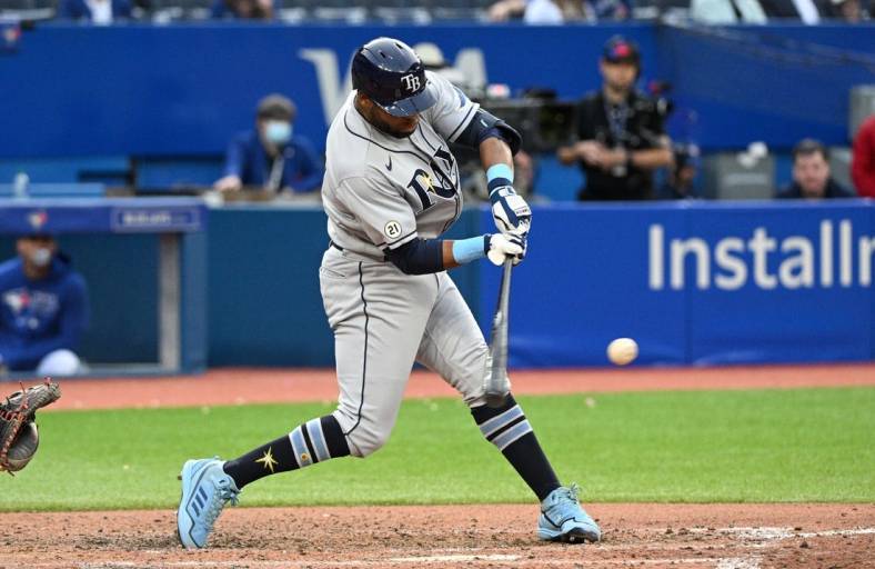 Sep 15, 2022; Toronto, Ontario, CAN;  Tampa Bay Rays designated hitter Manuel Margot (13) hits a three RBI double against the Toronto Blue Jays in the ninth inning at Rogers Centre. Mandatory Credit: Dan Hamilton-USA TODAY Sports