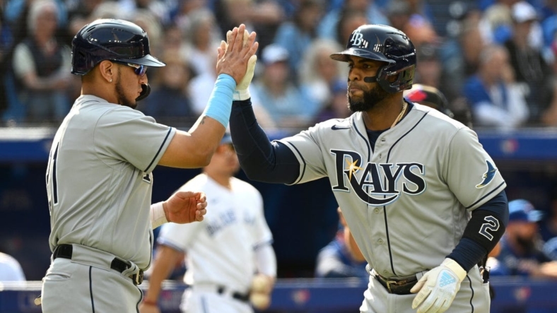 Sep 15, 2022; Toronto, Ontario, CAN;   Tampa Bay Rays third baseman Yandy Diaz (2, right) is greeted at home plate by second baseman Isaac Paredes (17) after hitting a three run home run against the Toronto Blue Jays in the second inning at Rogers Centre. Mandatory Credit: Dan Hamilton-USA TODAY Sports