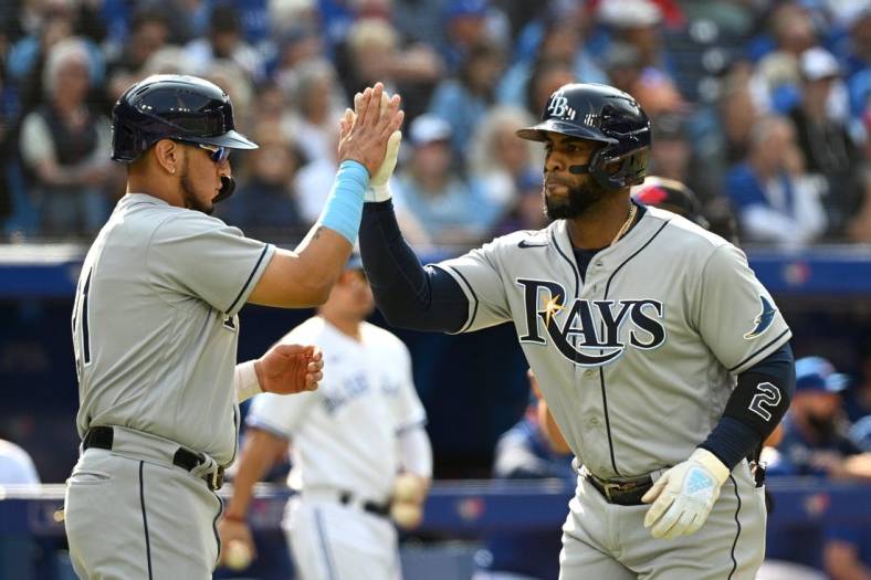 Sep 15, 2022; Toronto, Ontario, CAN;   Tampa Bay Rays third baseman Yandy Diaz (2, right) is greeted at home plate by second baseman Isaac Paredes (17) after hitting a three run home run against the Toronto Blue Jays in the second inning at Rogers Centre. Mandatory Credit: Dan Hamilton-USA TODAY Sports