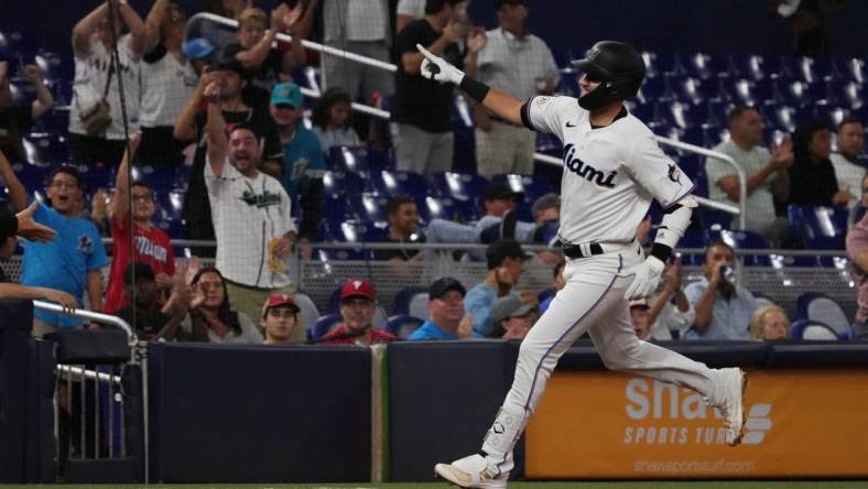 Sep 15, 2022; Miami, Florida, USA; Miami Marlins third baseman Jordan Groshans (65) celebrates while rounding the bases after hitting a solo home run in the third inning against the Philadelphia Phillies at loanDepot park. Mandatory Credit: Jasen Vinlove-USA TODAY Sports