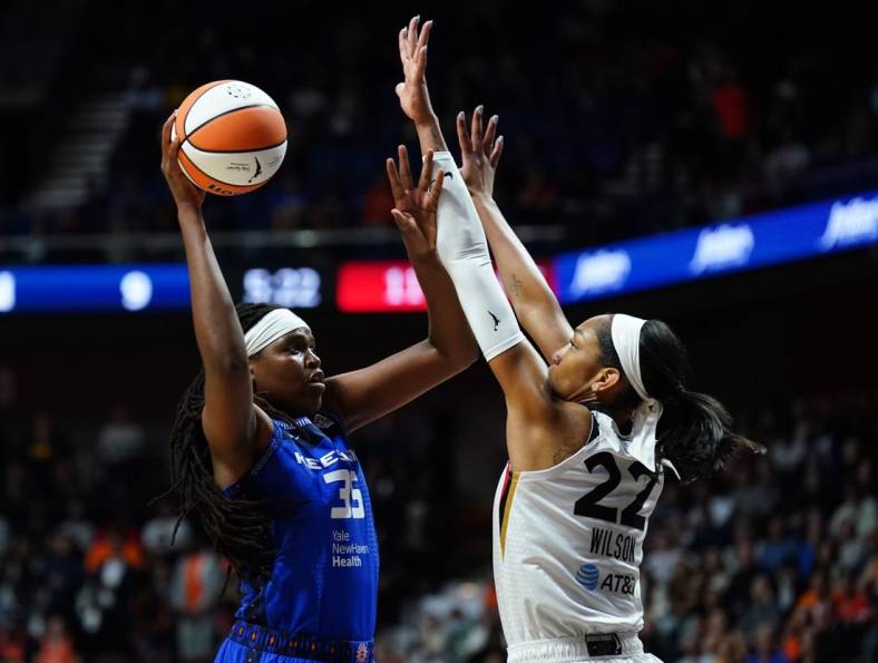 Sep 15, 2022; Uncasville, Connecticut, USA; Connecticut Sun forward Jonquel Jones (35) shoots against Las Vegas Aces forward A'ja Wilson (22) in the first quarter during game three of the 2022 WNBA Finals at Mohegan Sun Arena. Mandatory Credit: David Butler II-USA TODAY Sports