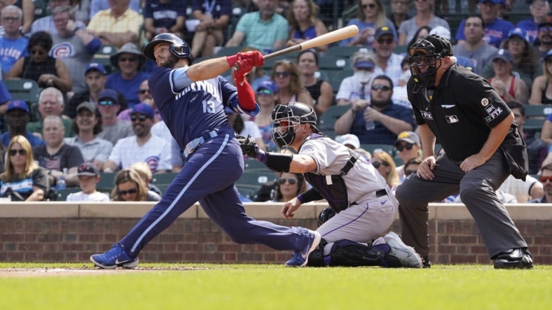 Sep 16, 2022; Chicago, Illinois, USA; Chicago Cubs third baseman David Bote (13) hits a single against the Colorado Rockies during the first inning at Wrigley Field. Mandatory Credit: David Banks-USA TODAY Sports