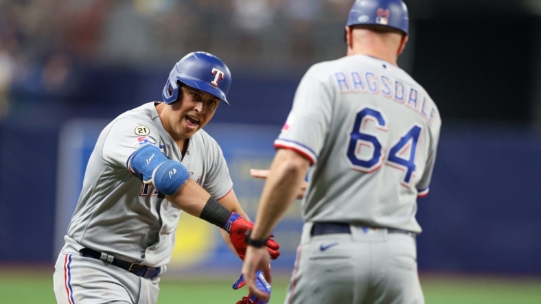 Sep 16, 2022; St. Petersburg, Florida, USA;  Texas Rangers first baseman Nathaniel Lowe (30) is congratulated by third base coach Corey Ragsdale (64) after hitting a two-run home run against the Tampa Bay Rays in the third inning at Tropicana Field. Mandatory Credit: Nathan Ray Seebeck-USA TODAY Sports