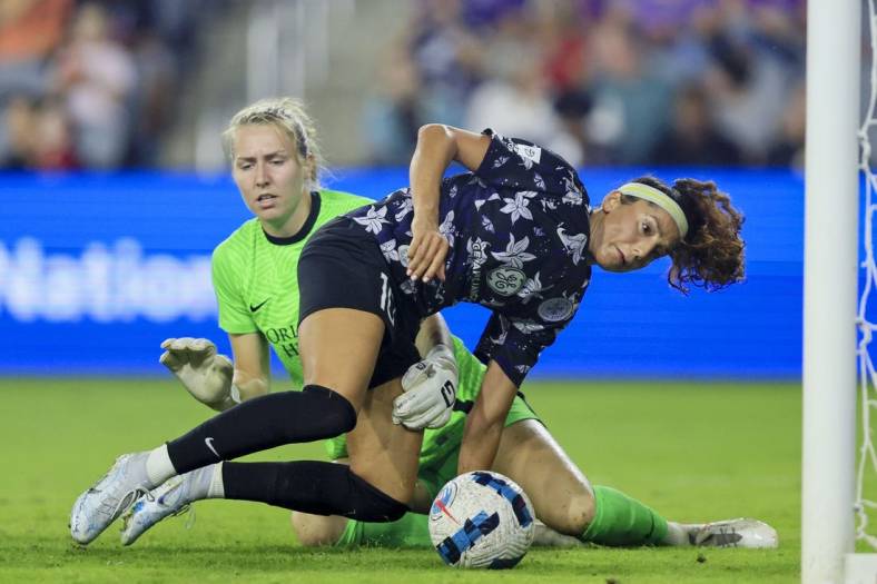 Sep 16, 2022; Louisville, Kentucky, USA; Racing Louisville FC forward Nadia Nadim (10) battles for the ball against Orlando Pride goalkeeper Anna Moorhouse (21) in the second half at Lynn Family Stadium. Mandatory Credit: Aaron Doster-USA TODAY Sports
