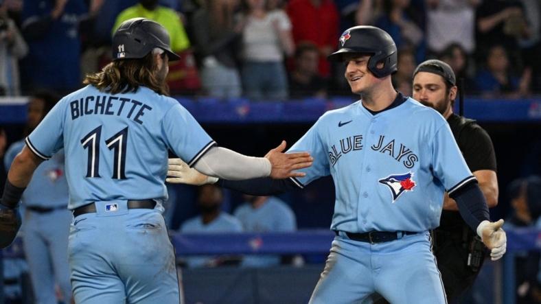 Sep 16, 2022; Toronto, Ontario, CAN;  Toronto Blue Jays third baseman Matt Chapman (26) is greeted by shortstop Bo Bichette (11) after hitting a two run home run against the Baltimore Orioles in the sixth inning at Rogers Centre. Mandatory Credit: Dan Hamilton-USA TODAY Sports