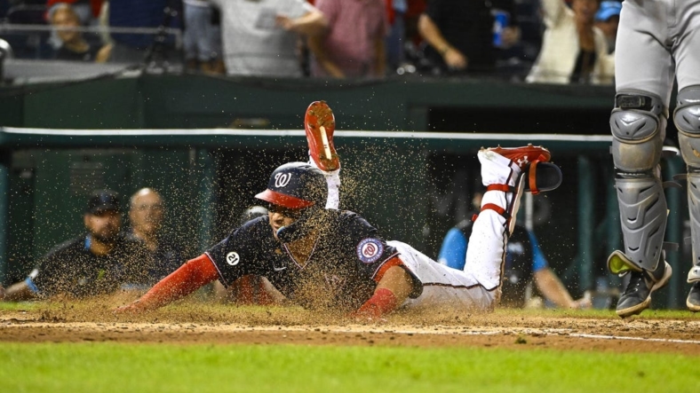 Sep 16, 2022; Washington, District of Columbia, USA; Washington Nationals first baseman Joey Meneses (45) slides into home for a home run against the Miami Marlins during the seventh inning at Nationals Park. Mandatory Credit: Brad Mills-USA TODAY Sports