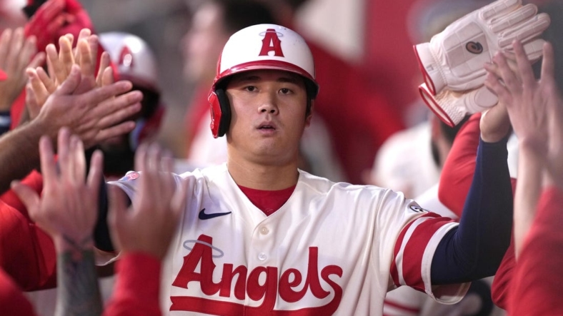 Sep 16, 2022; Anaheim, California, USA; Los Angeles Angels designated hitter Shohei Ohtani (17) is congratulated by teammates after scoring in the first inning against the Seattle Mariners at Angel Stadium. Mandatory Credit: Kirby Lee-USA TODAY Sports