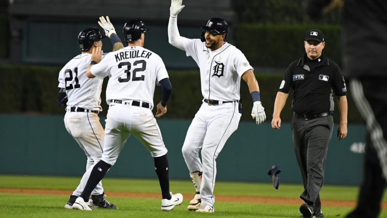 Sep 16, 2022; Detroit, Michigan, USA; Detroit Tigers right fielder Victor Reyes (22)  celebrates with shortstop Javier Baez (28)  and third baseman Ryan Kreidler (32) after hitting a sacrifice fly to score the game-winning run against the Chicago White Sox in the tenth inning at Comerica Park. Mandatory Credit: Lon Horwedel-USA TODAY Sports