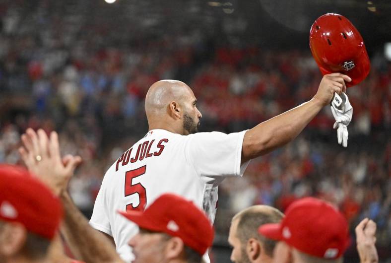 Sep 16, 2022; St. Louis, Missouri, USA;  St. Louis Cardinals designated hitter Albert Pujols (5) salutes the fans as he receives a standing ovation after hitting a game tying two run home run for his 698th career home run during the sixth inning against the Cincinnati Reds at Busch Stadium. Mandatory Credit: Jeff Curry-USA TODAY Sports