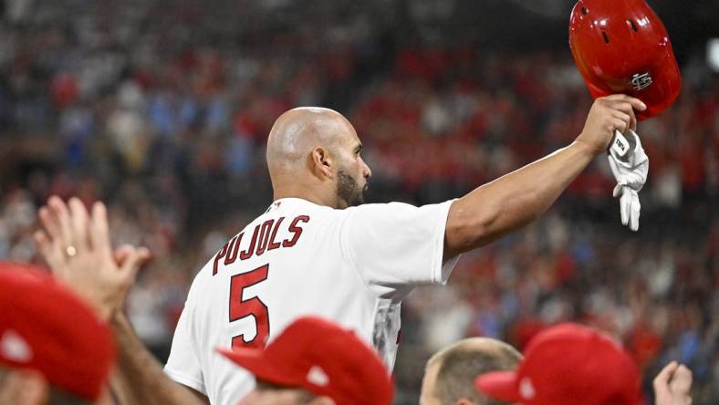 Sep 16, 2022; St. Louis, Missouri, USA;  St. Louis Cardinals designated hitter Albert Pujols (5) salutes the fans as he receives a standing ovation after hitting a game tying two run home run for his 698th career home run during the sixth inning against the Cincinnati Reds at Busch Stadium. Mandatory Credit: Jeff Curry-USA TODAY Sports