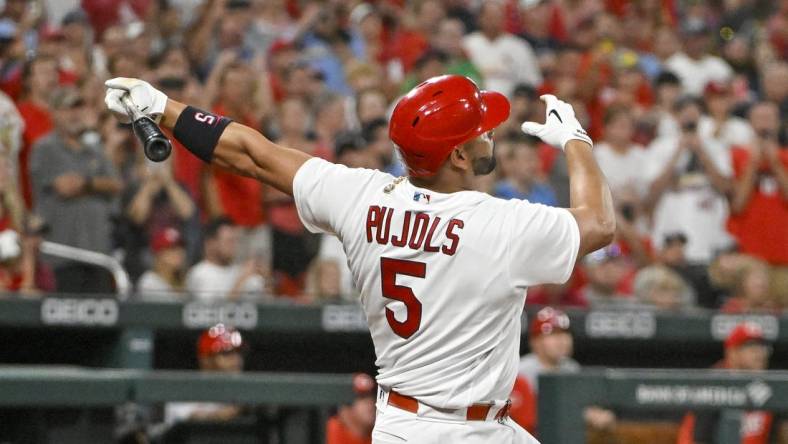 Sep 16, 2022; St. Louis, Missouri, USA;  St. Louis Cardinals designated hitter Albert Pujols (5) hits a game tying two run home run for his 698th career home run during the sixth inning against the Cincinnati Reds at Busch Stadium. Mandatory Credit: Jeff Curry-USA TODAY Sports