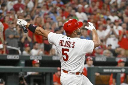 Sep 16, 2022; St. Louis, Missouri, USA;  St. Louis Cardinals designated hitter Albert Pujols (5) hits a game tying two run home run for his 698th career home run during the sixth inning against the Cincinnati Reds at Busch Stadium. Mandatory Credit: Jeff Curry-USA TODAY Sports
