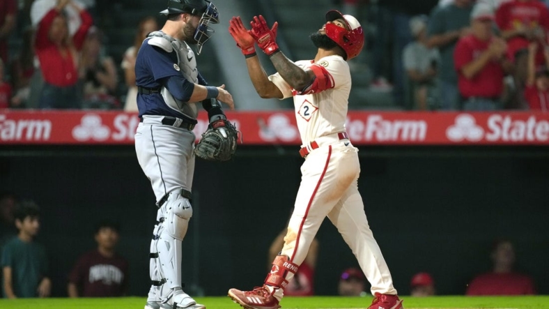 Sep 16, 2022; Anaheim, California, USA; Los Angeles Angels second baseman Luis Rengifo (2) celebrates after hitting a home run in the third inning as Seattle Mariners catcher Curt Casali (5) watches at Angel Stadium. Mandatory Credit: Kirby Lee-USA TODAY Sports