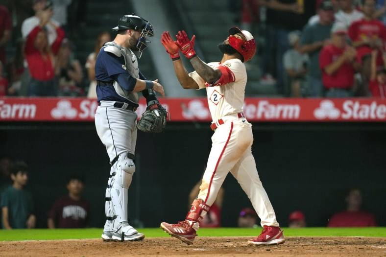 Sep 16, 2022; Anaheim, California, USA; Los Angeles Angels second baseman Luis Rengifo (2) celebrates after hitting a home run in the third inning as Seattle Mariners catcher Curt Casali (5) watches at Angel Stadium. Mandatory Credit: Kirby Lee-USA TODAY Sports