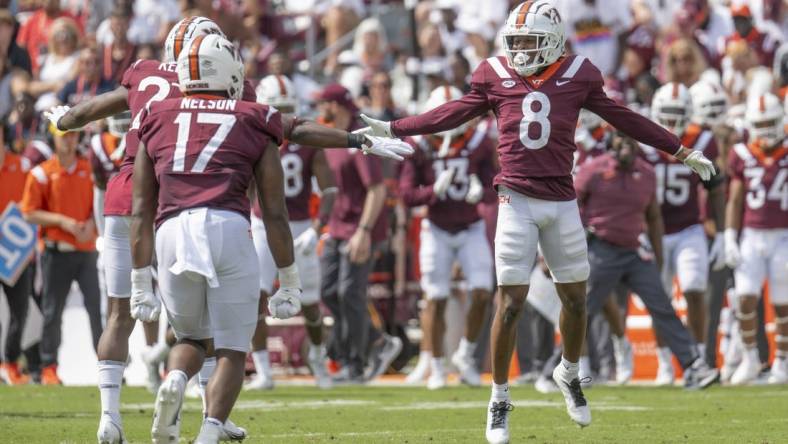 Sep 17, 2022; Blacksburg, Virginia, USA; Virginia Tech Hokies defender Brion Murray ( 8 ) celebrates with teammates after forcing the Wofford Terriers offense to punt in the second quarter at Lane Stadium. Mandatory Credit: Lee Luther Jr.-USA TODAY Sports