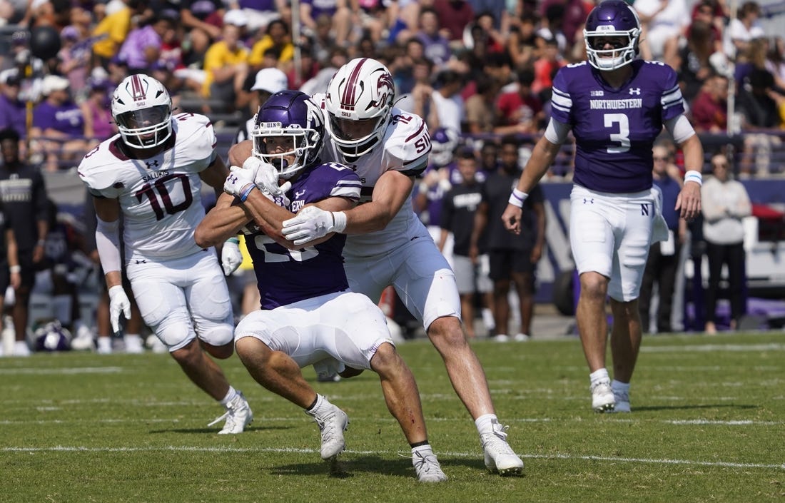 Sep 17, 2022; Evanston, Illinois, USA; Southern Illinois Salukis linebacker Branson Combs (12) tackles Northwestern Wildcats running back Evan Hull (26) during the first half at Ryan Field. Mandatory Credit: David Banks-USA TODAY Sports