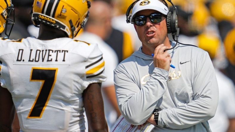 Sep 17, 2022; Columbia, Missouri, USA; Missouri Tigers head coach Eliah Drinkwitz talks with wide receiver Dominic Lovett (7) during the second half against the Abilene Christian Wildcats at Faurot Field at Memorial Stadium. Mandatory Credit: Jay Biggerstaff-USA TODAY Sports
