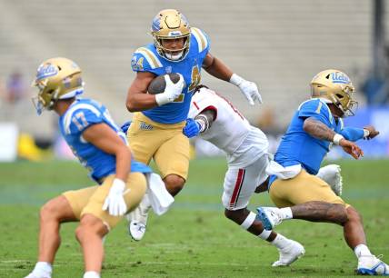 Sep 17, 2022; Pasadena, California, USA; UCLA Bruins running back Zach Charbonnet (24) carries the ball for a first down in the first half against the South Alabama Jaguars at the Rose Bowl. Mandatory Credit: Jayne Kamin-Oncea-USA TODAY Sports