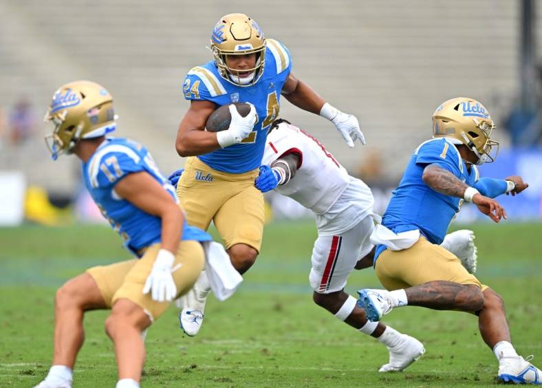 Sep 17, 2022; Pasadena, California, USA; UCLA Bruins running back Zach Charbonnet (24) carries the ball for a first down in the first half against the South Alabama Jaguars at the Rose Bowl. Mandatory Credit: Jayne Kamin-Oncea-USA TODAY Sports