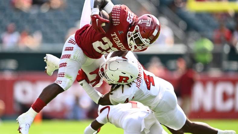 Sep 17, 2022; Philadelphia, Pennsylvania, USA; Rutgers Scarlet Knights defensive back Desmond Igbinosun (4) tackles Temple Owls running back Edward Saydee (23) in the first half at Lincoln Financial Field. Mandatory Credit: Kyle Ross-USA TODAY Sports