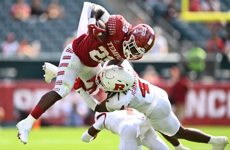 Sep 17, 2022; Philadelphia, Pennsylvania, USA; Rutgers Scarlet Knights defensive back Desmond Igbinosun (4) tackles Temple Owls running back Edward Saydee (23) in the first half at Lincoln Financial Field. Mandatory Credit: Kyle Ross-USA TODAY Sports