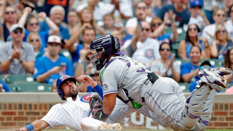 Sep 17, 2022; Chicago, Illinois, USA; Colorado Rockies catcher Elias Diaz (35) tags out Chicago Cubs first baseman Alfonso Rivas (36) at home during the fifth inning at Wrigley Field. Mandatory Credit: Jon Durr-USA TODAY Sports