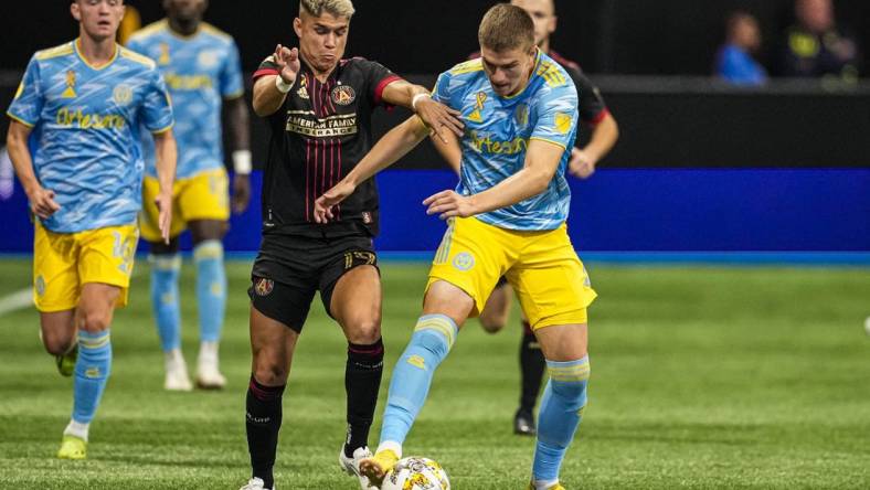 Sep 17, 2022; Atlanta, Georgia, USA; Atlanta United midfielder Luiz Ara  jo (19) tries to prevent Philadelphia Union forward Mikael Uhre (7) from advancing the ball during the first half at Mercedes-Benz Stadium. Mandatory Credit: Dale Zanine-USA TODAY Sports