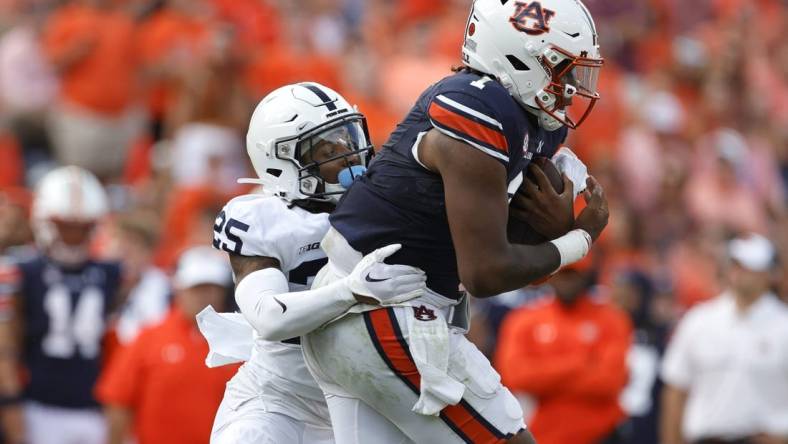 Sep 17, 2022; Auburn, Alabama, USA; Auburn Tigers quarterback T.J. Finley (1) is tackled by Penn State Nittany Lions cornerback Daequan Hardy (25) during the second quarter at Jordan-Hare Stadium. Mandatory Credit: John Reed-USA TODAY Sports