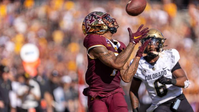 Sep 17, 2022; Minneapolis, Minnesota, USA; Minnesota Golden Gophers wide receiver Chris Autman-Bell (7) catches a 39 yard touchdown pass from quarterback Tanner Morgan (2), Colorado Buffaloes cornerback Nikko Reed (6) cornerback Nikko Reed (6) on defense catches a  at Huntington Bank Stadium. Mandatory Credit: Matt Blewett-USA TODAY Sports