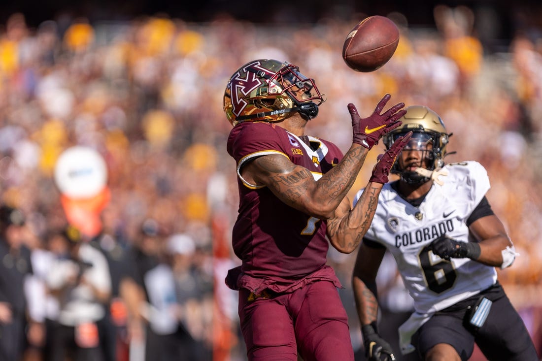 Sep 17, 2022; Minneapolis, Minnesota, USA; Minnesota Golden Gophers wide receiver Chris Autman-Bell (7) catches a 39 yard touchdown pass from quarterback Tanner Morgan (2), Colorado Buffaloes cornerback Nikko Reed (6) cornerback Nikko Reed (6) on defense catches a  at Huntington Bank Stadium. Mandatory Credit: Matt Blewett-USA TODAY Sports