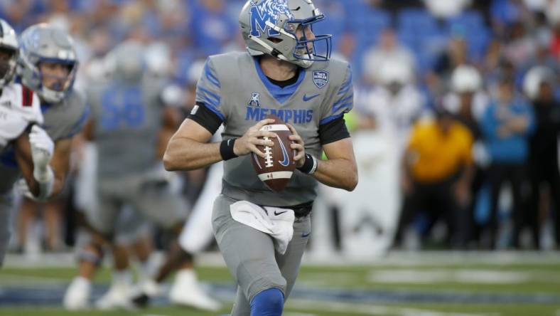 Sep 17, 2022; Memphis, Tennessee, USA; Memphis Tigers quarterback Seth Henigan (5) scrambles during the first half against the Arkansas State Red Wolves at Liberty Bowl Memorial Stadium. Mandatory Credit: Petre Thomas-USA TODAY Sports