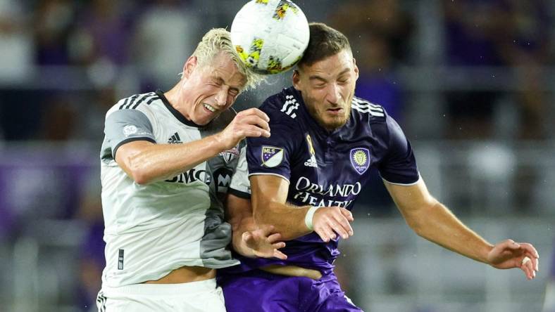 Sep 17, 2022; Orlando, Florida, USA;  Orlando City forward Ercan Kara (9) and Toronto FC defender Lukas MacNaughton (5) head the ball in the first half at Exploria Stadium. Mandatory Credit: Nathan Ray Seebeck-USA TODAY Sports