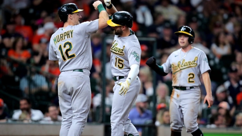 Sep 17, 2022; Houston, Texas, USA; Oakland Athletics right fielder Seth Brown (15) is congratulated by catcher Sean Murphy (12) after hitting a three-run home run to right field against the Houston Astros during the fifth inning at Minute Maid Park. Mandatory Credit: Erik Williams-USA TODAY Sports