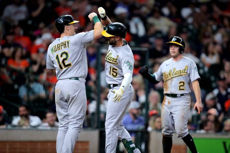 Sep 17, 2022; Houston, Texas, USA; Oakland Athletics right fielder Seth Brown (15) is congratulated by catcher Sean Murphy (12) after hitting a three-run home run to right field against the Houston Astros during the fifth inning at Minute Maid Park. Mandatory Credit: Erik Williams-USA TODAY Sports