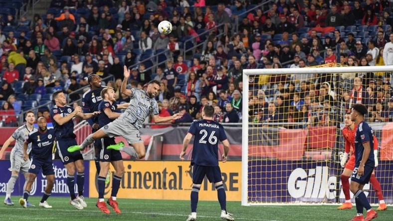 Sep 17, 2022; Foxborough, Massachusetts, USA; CF Montreal defender Rudy Camacho (4) makes a leaping play for the ball  during the first half of a match against against the New England Revolution at Gillette Stadium. Mandatory Credit: Eric Canha-USA TODAY Sports