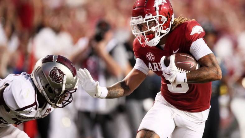 Sep 17, 2022; Fayetteville, Arkansas, USA; Arkansas Razorbacks wide receiver Jadon Haselwood (9) pushes off of a Missouri State Bears defender in the second quarter as he runs after a catch for a touchdown at Donald W. Reynolds Razorback Stadium. Mandatory Credit: Nelson Chenault-USA TODAY Sports