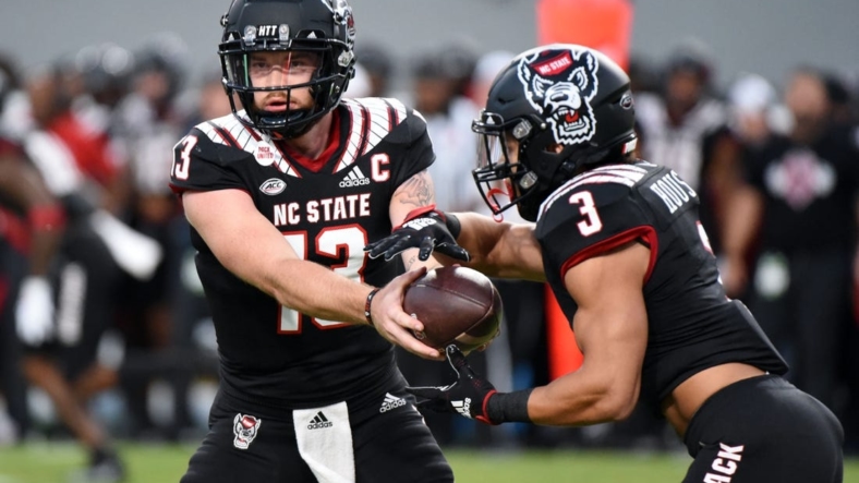Sep 17, 2022; Raleigh, North Carolina, USA; North Carolina State Wolfpack quarterback Devin Leary (13) hands off to  running back Jordan Houston (3) during the first half against the Texas Tech Red Raiders at Carter-Finley Stadium. Mandatory Credit: Rob Kinnan-USA TODAY Sports