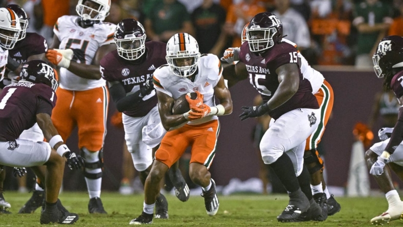 Sep 17, 2022; College Station, Texas, USA; Miami Hurricanes running back Jaylan Knighton (4) runs with the ball against the Texas A&M Aggies during the second quarter at Kyle Field. Mandatory Credit: Jerome Miron-USA TODAY Sports